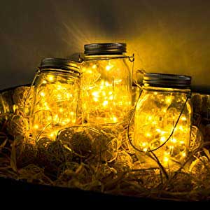 Mason Solar Fairy Lights in a jar with golden lights creating a warm, decorative ambiance around a cozy setting.