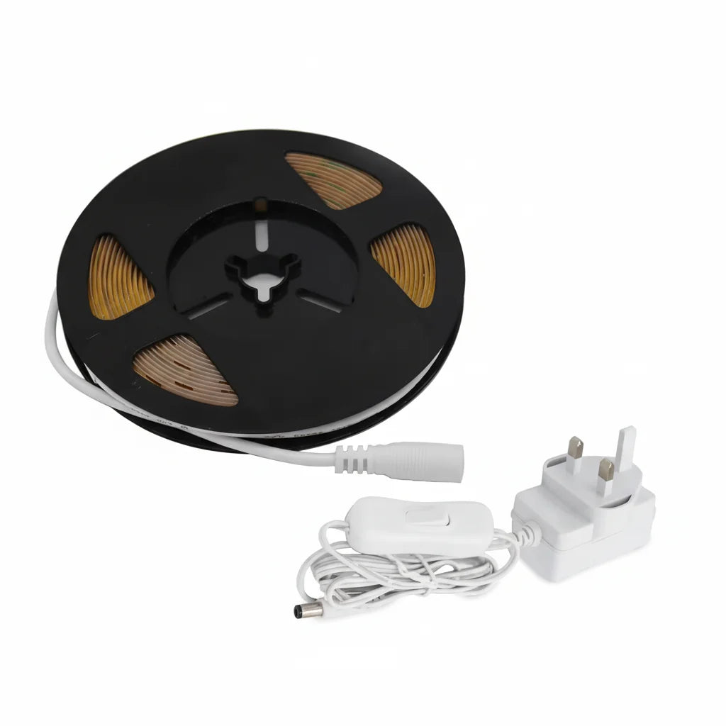 Spool of black ribbon with white connectors and adapter on a white background